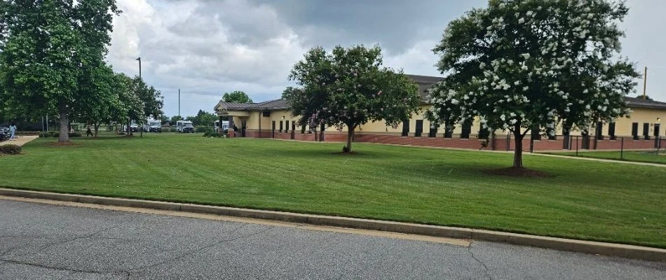 Commercial grounds in Phenix City, AL, with a large lawn and trees.