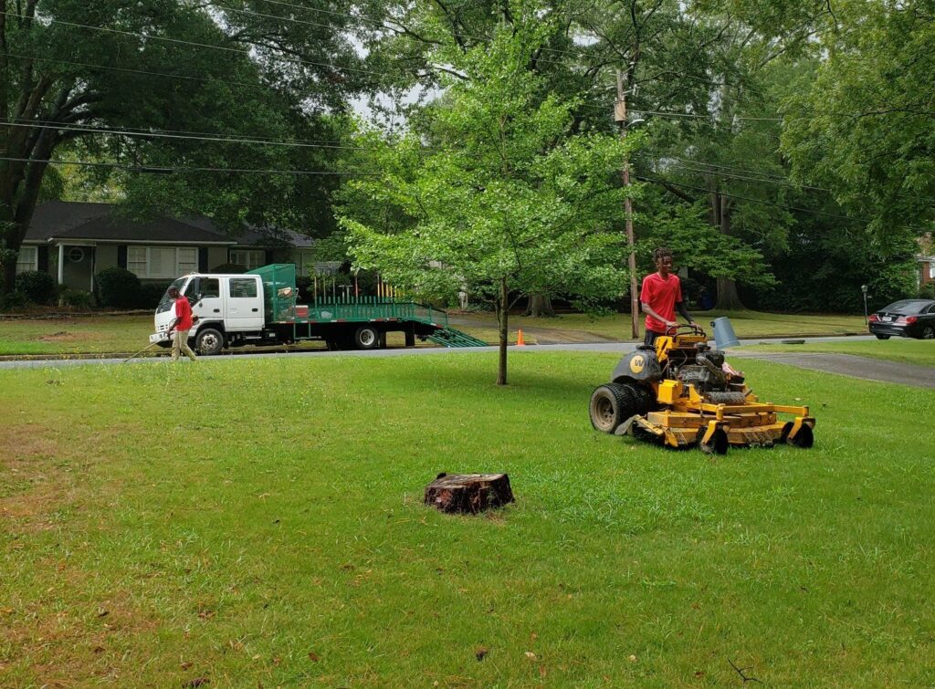 Lawn care company mowing a yard